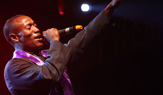 Yoyo performing at a concert (above). Right, he cuts a dapper pose. 
