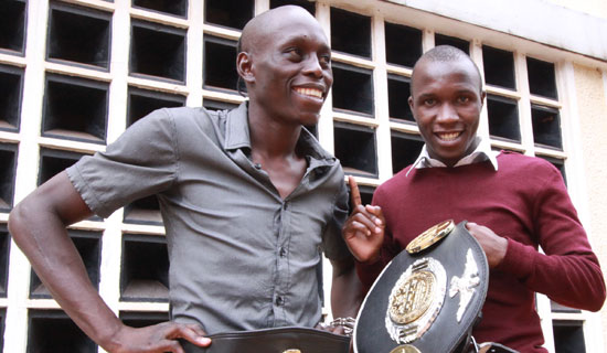Ronald Mugula (left) a kickboxing champion hangs with fan Lubega Edrin. Photo By Ismail Kezaala