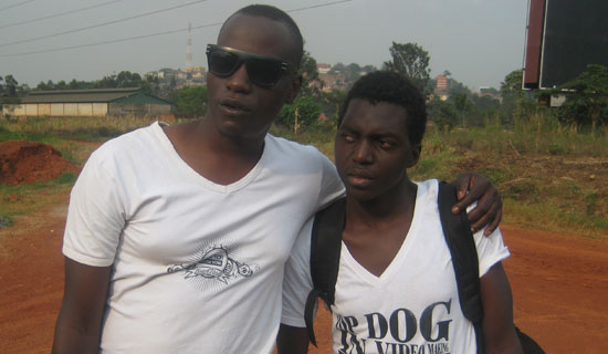 Jah Live video director, Frank and his fan.   PHOTO BY ISAAC  SSEJJOMBWE