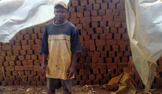 Goobi the brick maker. Photo by Isaac Ssejjombwe. 