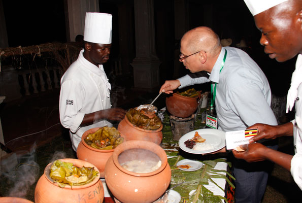 A guest serves Ugandan food cooked in the traditional style at last year’s Mavuno Yetu. Various East African cuisines are on the menu. PHOTO BY Abubaker Lubowa 