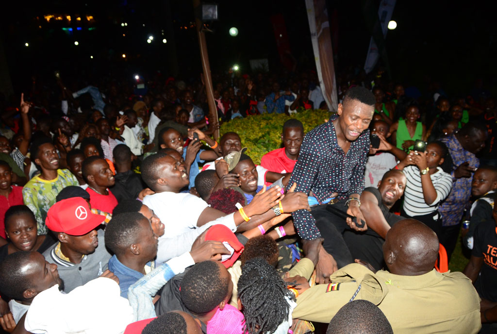 Chameleone mobbed by crowds during his performance. Below, some of the fireworks display at Sheraton Kampala Hotel. PHOTOS BY MICHAEL KAKUMIRIZI