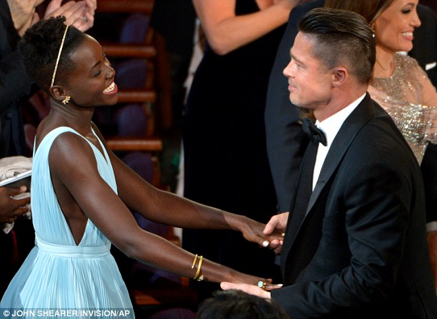Lupita Nyong'o hugs Brad Pitt at the Oscars in 2014