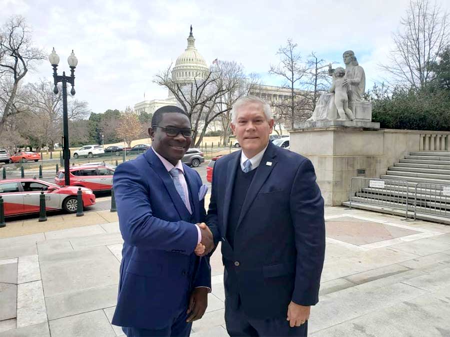 Men of importantance . Mr Pemba (L)shakes hands with Peter Anderson, an American politician from Texas who served in the US House of Representatives for 11 terms,soon after the important meeting at Washington DC senate