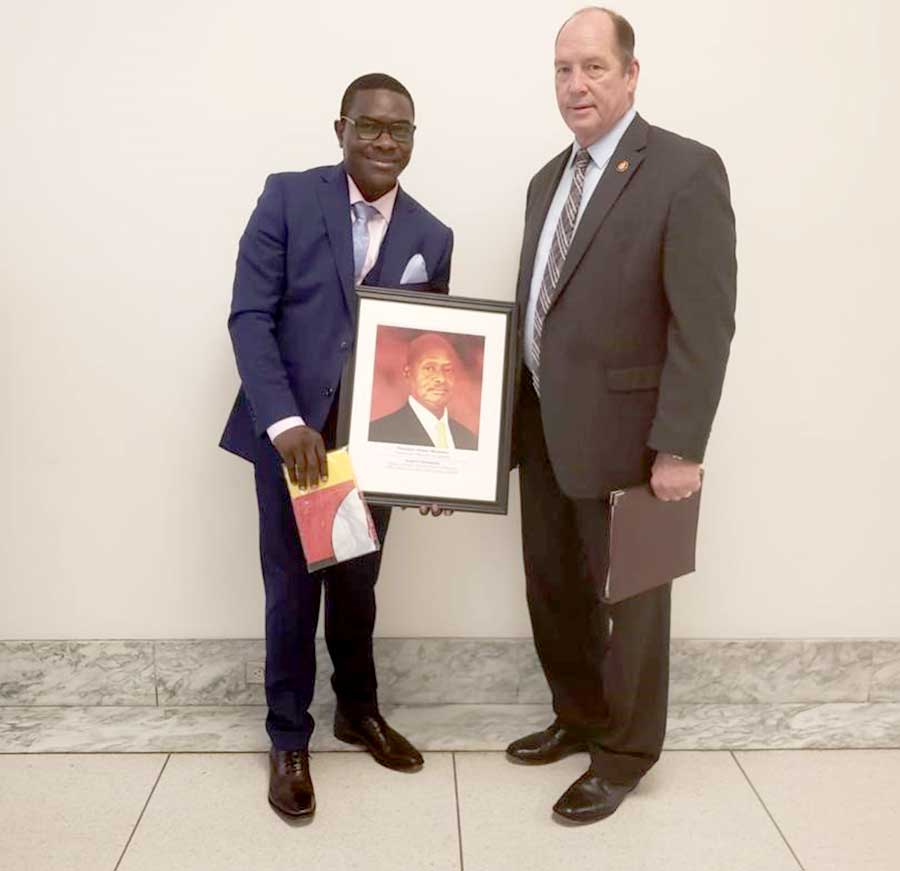 Pemba sealed his meeting with the high caliber personalities by handing over a Ugandan flag and President Museveni portrait to Mr. Theodore Scott Yoho (R), a US Representative for Florida T.C District