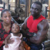 Cobra i s back on his feet after the 2010 shooting. He poses with his wife and child in his gym. PHOTO BY JUDE KATENDE