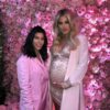 Khloe Kardashian poses for a bump photo with her elder sister Kim Kardashian