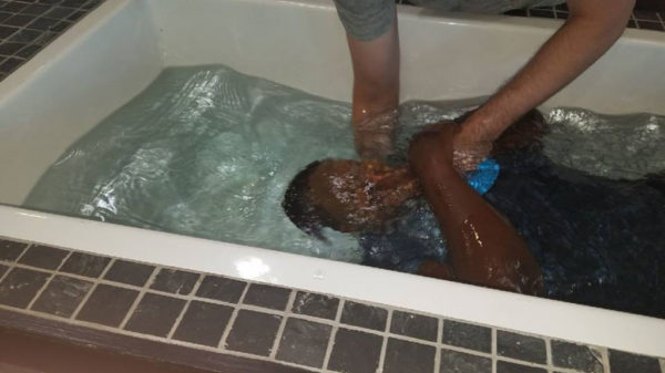 Remmy Bahati getting baptised at new christian life church, in Virginia, US.