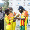 Jamaican Reggae star Riley (R) admires trophies presented to her by the Lady Cricket Cranes skipper Kevin Awino (L) and Janet Mbabazi (C) at the end of the Tarrus Riley Cricket Carnival in Lugogo yesterday